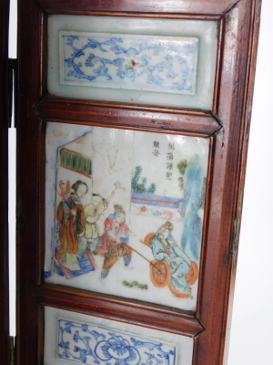 A 19thC Chinese porcelain table screen, four fold, with blue and white panels over and beneath central famille rose enamelled court scenes with inscriptions to the centre, 41cm high. - 5