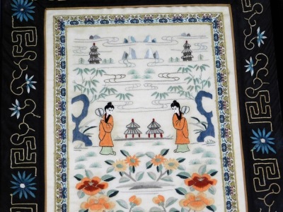 A Chinese silk panel, made from a pair of sleeve bands, embroidered with figures and pagodas in a garden setting, against an ivory ground, within a black border, framed and glazed, 70cm x 37cm. - 3