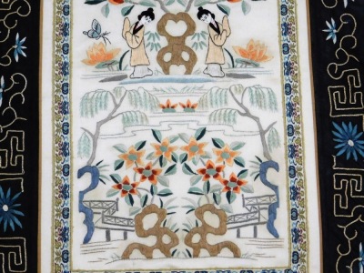 A Chinese silk panel, made from a pair of sleeve bands, embroidered with figures and pagodas in a garden setting, against an ivory ground, within a black border, framed and glazed, 70cm x 37cm. - 4