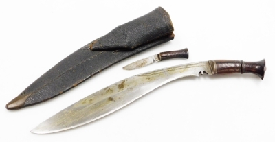 A Nepalese kukri, with edged and curved steel blade, having two narrow fullers to the back edge, with additional sharpening knife, in a leather sheath.