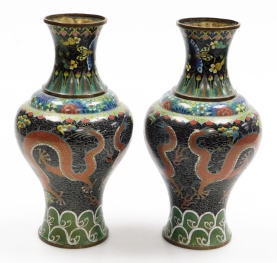 A pair of late 19thC Chinese cloisonne enamel vases, with brass rims, decorated with Imperial dragons in the clouds chasing a flaming pearl, on a black ground, within floral and acanthus leaf borders, 32.5cm high. - 3