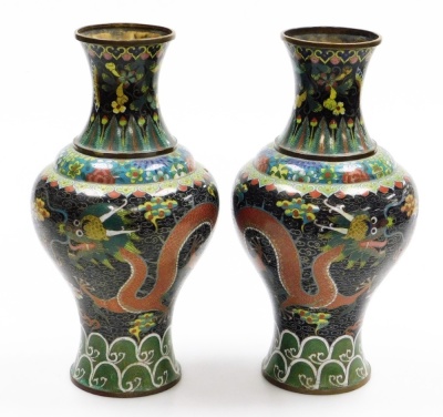 A pair of late 19thC Chinese cloisonne enamel vases, with brass rims, decorated with Imperial dragons in the clouds chasing a flaming pearl, on a black ground, within floral and acanthus leaf borders, 32.5cm high. - 4