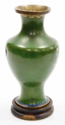 A Chinese cloisonne enamel vase, with brass rims, of baluster form, decorated with prunus blossom on a green ground, 22.5cm high, on a hardwood stand. (AF) - 3