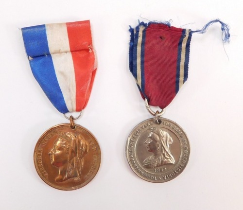 A Queen Victoria copper Golden Jubilee medal 1887, with a red, white and blue ribbon, together with a Diamond Jubilee medal 1897, in nickel, with a predominantly red, narrow white and blue ribbon. (2)