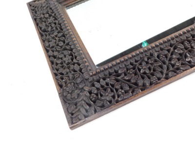 A Burmese carved wooden wall mirror, with pierced and fret carved border, with a rectangular arched top mirror plate, 51cm high, 34cm wide. - 4