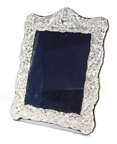 An Elizabeth II silver framed photograph frame, in rococo style, Sheffield 1990, picture size 25cm x 19cm, the frame with blue lined velvet back, 37cm x 28cm.