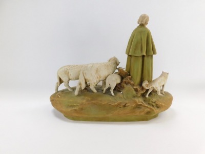 A Royal Dux figure group of sheep and a shepherdess with water vessel, the shepherdess modelled stood on a grassy bank, wearing a cloak, trousers, and boots, a hat clasped between his hands, a sheep dog stood to his right, and a ram, ewe and two lambs sto - 4