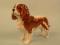 A Beswick King Charles spaniel decorated in brown and white