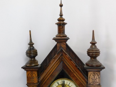 A walnut Vienna wall clock, the arched top with turned finials, with white enamel numeric dial, carved cresting, 90cm high, 34cm wide, 17cm deep. - 3