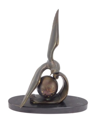 M Leducq. An Art Deco bronzed spelter mantel clock, with seagull over an orb on an oval black marble base, 64cm high, 45cm wide, 16cm deep.