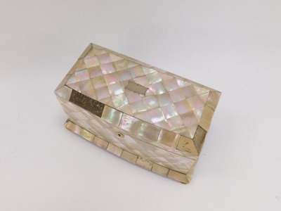 A 19thC mother of pearl inlaid tea caddy, the top with canted corners and a plated shield escuteon, on bun feet, opening to reveal a purple velvet lined interior, 14cm high, 24cm wide, 13cm deep. (AF) - 2