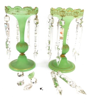 A pair of Victorian green glass lustres, each with a fluted top and domed foot with applied gilt detailing and various crystal droplets, 27cm high. (AF)