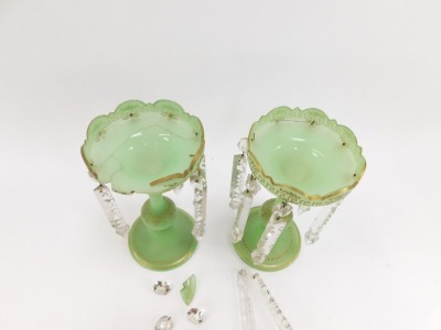 A pair of Victorian green glass lustres, each with a fluted top and domed foot with applied gilt detailing and various crystal droplets, 27cm high. (AF) - 2