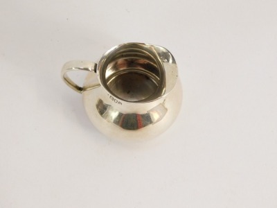 A George V miniature cream jug, of plain design, Charles Edwards London 1915, 1½oz. - 2