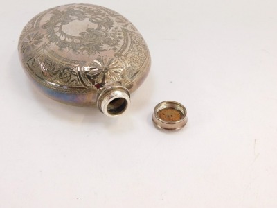 A 20thC silver plated hip flask, with foliate scroll decoration and central shield inscribe W Stephenson January 15th 1901, white metal unmarked, with screw in top, 14cm high. - 3