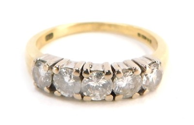 An 18ct gold diamond five stone dress ring, set with five round brilliant cut stones, each approx 0.25cts, totalling approx 1.25cts overall, in four claw white gold setting, on a yellow metal band, size Q½, 4.8g all in, boxed.