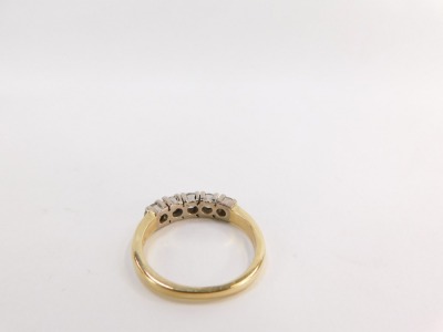 An 18ct gold diamond five stone dress ring, set with five round brilliant cut stones, each approx 0.25cts, totalling approx 1.25cts overall, in four claw white gold setting, on a yellow metal band, size Q½, 4.8g all in, boxed. - 2