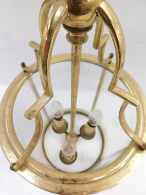 A brass lantern, with an arched top and three fittings and four glass sections, 56cm high before hanging. - 3