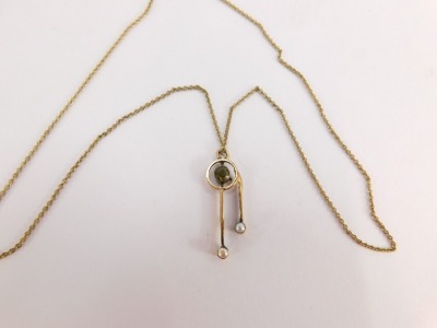 An Edwardian pendant and chain, the drop pendant with peridot and two seed pearls, 3cm high, on a fine link yellow metal neck chain, 40cm long, stamped 9ct to clasp, 3.1g all in, boxed. - 2