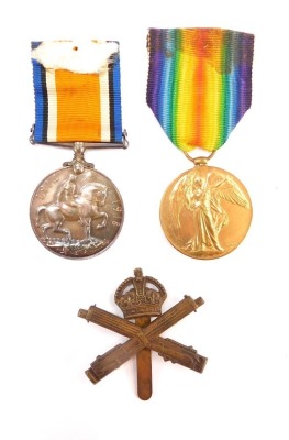 A WWI Great War and Victory Medal pair, named for Pte E H Carvell, Machine Gun Corps, 128045, together with a cap badge. (3)