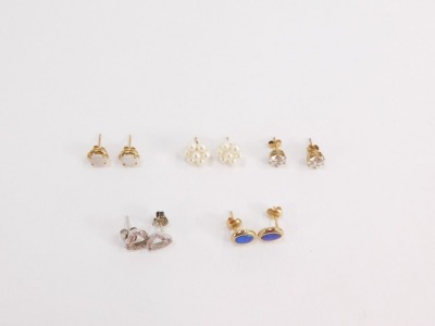 Five pairs of 9ct gold and other earrings, comprising a pair of 9ct gold and opal studs, a pair of 9ct gold and fire opal studs, a pair of 9ct gold and paste stone set studs, silver heart studs and a further cluster pair unmarked, 7.3g all in. (5) - 2