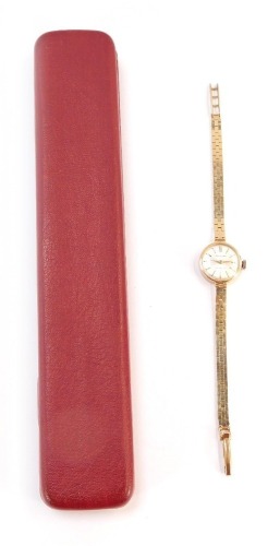 A Garrard 9ct lady's wristwatch, with small silvered dial, bearing inscription to reverse, Jaguar Daimler Cars Coventry Presented to Mrs R M Close 1952 - 1975, the dial 1.5cm wide, on brickette effect bracelet, 19cm long, 16.2g all in, boxed.