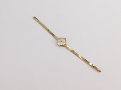 A Garrard 9ct lady's wristwatch, with small silvered dial, bearing inscription to reverse, Jaguar Daimler Cars Coventry Presented to Mrs R M Close 1952 - 1975, the dial 1.5cm wide, on brickette effect bracelet, 19cm long, 16.2g all in, boxed. - 3