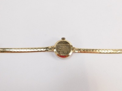 A Garrard 9ct lady's wristwatch, with small silvered dial, bearing inscription to reverse, Jaguar Daimler Cars Coventry Presented to Mrs R M Close 1952 - 1975, the dial 1.5cm wide, on brickette effect bracelet, 19cm long, 16.2g all in, boxed. - 4