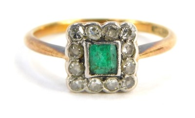 An emerald and diamond cluster ring, the square set panel with square cut emerald in rub over setting, surrounded by diamonds on a thin band, yellow metal stamped 18ct plat., ring size L, 2.3g all in.