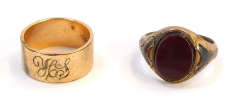 Two rings, comprising a 9ct gold signet ring, with red blood stone, and later soldered detail, ring size O, together with a wedding band marked gold steel, 3.7g all in.