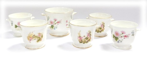 A group of Crown Staffordshire china, comprising three small fairy and robin jardinieres, 10cm high, and three wild flowers jardinieres, one large 12cm high, and two small 10cm high. (6, AF)