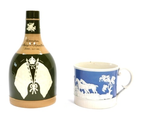 A Copeland Spode Coronation of King George V and Queen Mary commemorative bottle, dated 1911, on a green glazed ground with applied white crests, 21cm high, and a basalt hunting mug, 10cm diameter. (2)