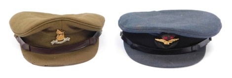 Two military peaked caps, comprising an RAF cap and a Royal Army Pay Corps cap from Reid Bros, London.