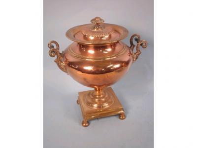 A George IV copper and brass two handled samovar cast with leaves on a