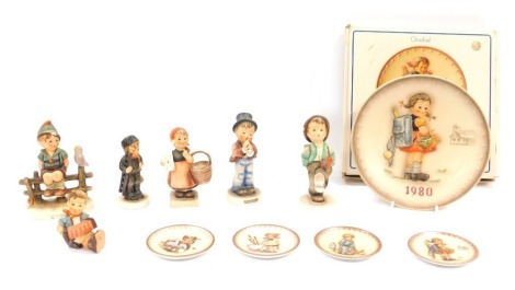 A group of Goebel Hummel figures, comprising The Annual Plate for 1980, boxed, four pin dishes, 1986, 1974, 1994 and 1980, various figures comprising child playing clarinet, child walking with umbrella, child with basket, child playing accordion, child ca