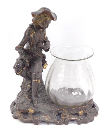 A bronzed terracotta figure of a child perched on tree trunk, looking over glass vase, with rococo scrolled base, 39cm high, 33cm wide.