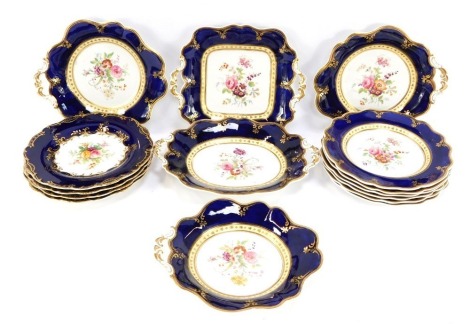 Late 19thC dessert porcelain, in royal blue ground with hand painted flower detailing, comprising two serving dishes, three scallop trays, and ten dinner plates.