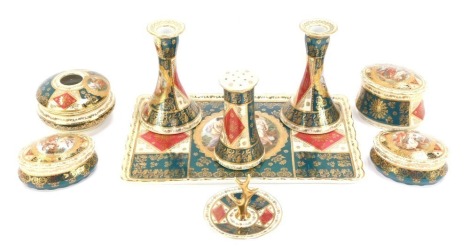 Continental porcelain dressing table set, comprising tray, two candlesticks and ring stand, three trinket dishes, a smelling salts jar, and a powder, all in the Limoges style with heavy green, red and cream gilt detailing. (a quantity)