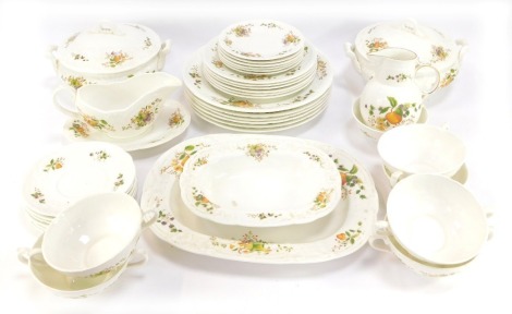 A Coalport Wenlock Fruit pattern part dinner service, comprising two tureens and covers, gravy boat and saucer, serving bowl, meat plate, dessert bowl, six soup bowls, milk jug, six saucers, six side plates, six small plates and six dinner plates.