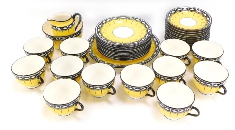 A Chelson China 1950's style tea service, on a yellow ground with black borders, comprising twelve tea cups and saucers, milk jug, sugar bowl, twelve cake plates and two serving plates.