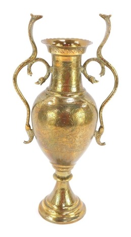 An Indian brass vase, the handles in the form of serpents, with a flared and shaped rim, 38cm high.