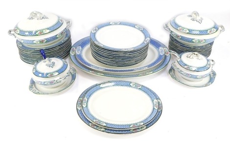 A Corona ware dinner service in the Premier pattern, comprising two meat plates, two large tureens and lids, two small tureens, lids and serving spoons, a set of three graduated small serving plates, two cake plates, twelve dinner plates, twelve medium pl