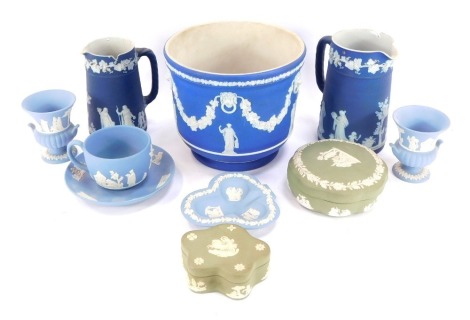 A group of Wedgwood Jasperware, to include two dark blue jugs, a dark blue planter, a light blue cup and saucer, pin dish, and campana vase, and two green trinket boxes. (a quantity)