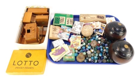 A group of vintage toys and games, comprising a pair of Taylor Roll of London carpet bowls, playing cards, wooden doll's house furniture, Empire domino set, Lotto Housey Housey, collection of marbles, etc. (1 tray)