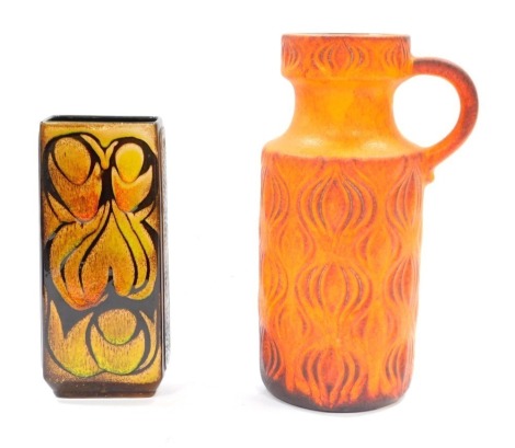 Art pottery, comprising an orange wave design water jug, 27cm high, and a brown and yellow glazed decorative vase, possibly Poole, 21cm high, both unmarked. (2)