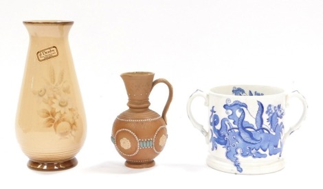 A Denby Memories stoneware vase, 21cm high, a Doulton Lambeth Silicon ware milk jug, 12cm high, and a Masons blue and white ironstone loving cup, 11cm high. (3)