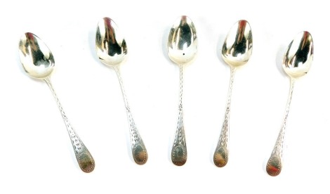 Five Victorian silver teaspoons, each with star bright engraved fiddle pattern top, circular crest lacking initials, beaded outer border, London 1875, and one 1821, 2oz.