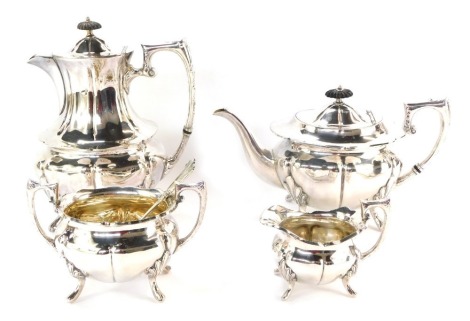 A silver plated four piece service, comprising coffee pot and teapot, milk jug, sugar bowl and a later serving spoon, with ebonised knop. (5)