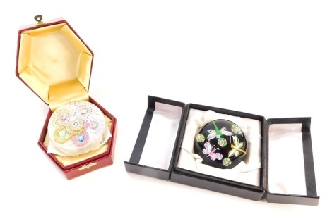 Two glass paperweights, comprising a Perthshire millefiori paperweight, boxed, and a Jay Glass butterfly and dragonfly black domed paperweight, boxed. (2)