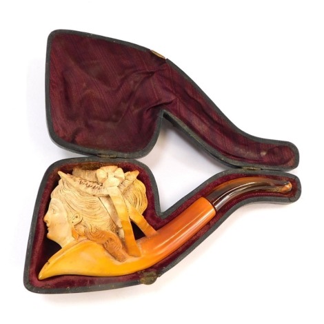 A meerschaum pipe, with amber cheroot and carved figure of a lady, in a black fitted case with crushed velvet interior, 16cm diameter.